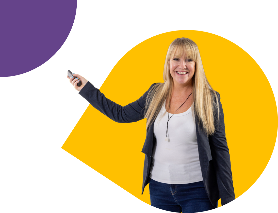 A photo of Hannah, smailing at the camera, holding a presentation clicker.